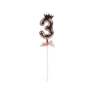 Number 3 on a stick with a rose gold crown